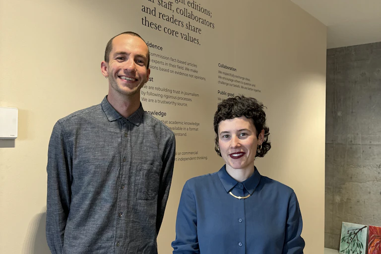 A photo of two The Conversation staff members in the office