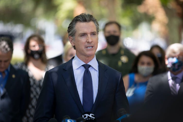 Gavin Newsom speaking in front of a crowd.