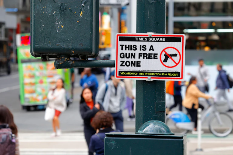 A sign saying "Times Square This is a Gun Free Zone" in Midtown Manhattan, New York City.