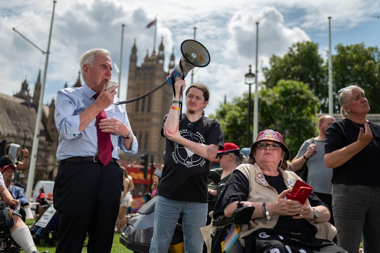 John McDonnell speaking into a megaphone outside parliament.