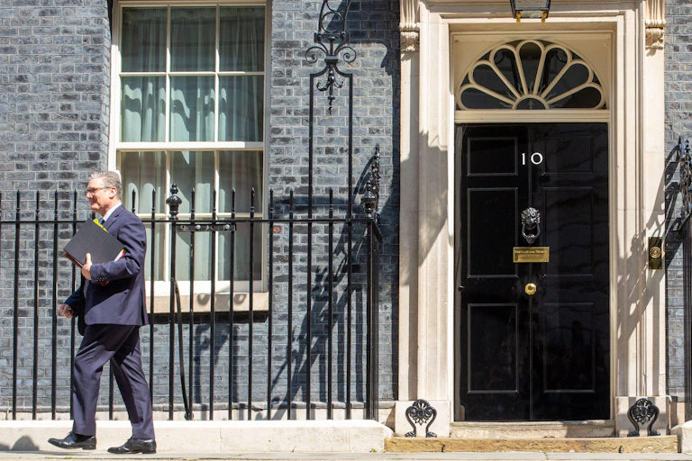 Keir Starmer walking outside of 10 Downing Street.