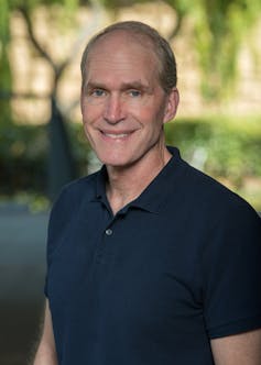 Author Rob Jackson wearing black T shirt looking to cam