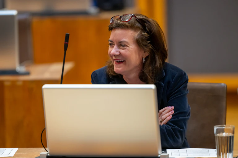 Eluned Morgan smiles behind her laptop