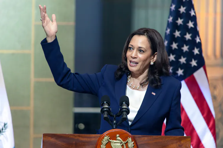 Kamala Harris stood in front of a US flag delivering a speech.