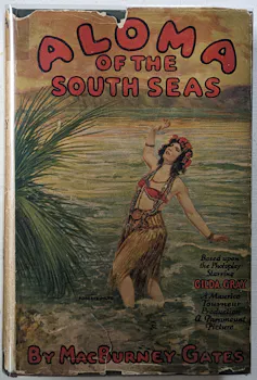 Cover of the novel Aloma of the South Seas, showing a girl in a raffia skirt and bikini top standing in the waves, a palm tree next to her