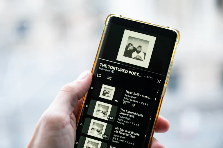A smartphone displays Taylor Swift's new album "The Tortured Poets Department" on Spotify.