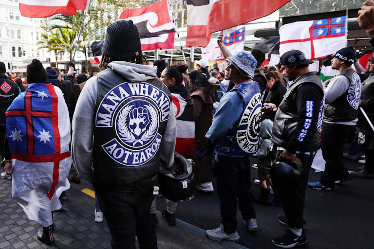 Black power gang members with tino rangatiratanga flags