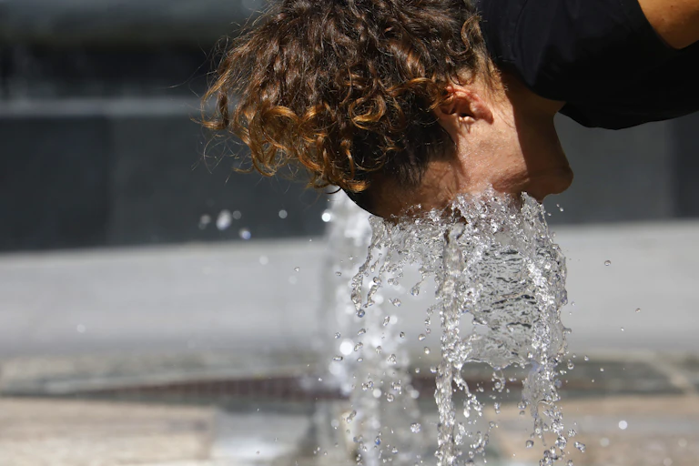 person with face in fountain