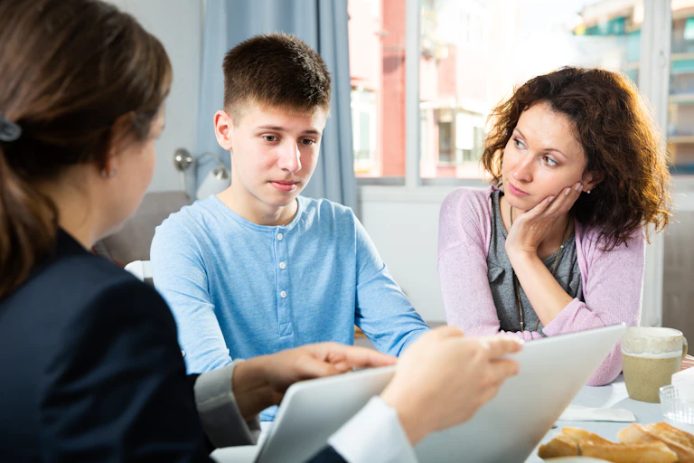 Mother and teen boy meet teacher