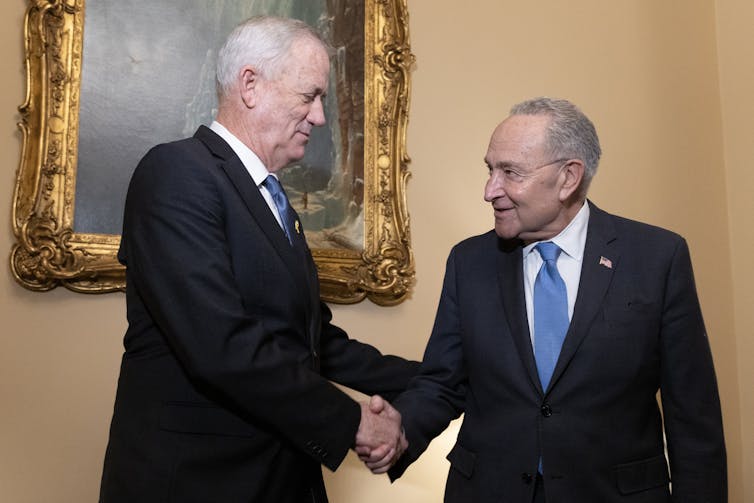 Israeli politician Benny Gantz shakes hands with US senate majority leader Chuck Schumer.