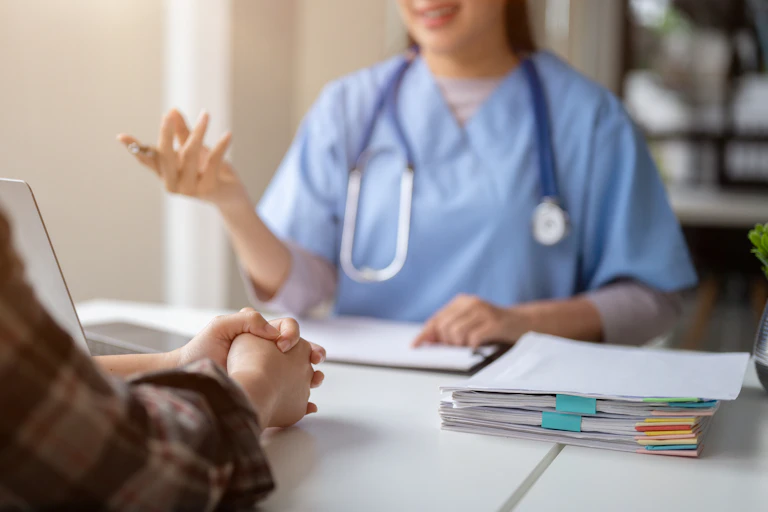 Close-up hand image of a serious patient having a medical consultation with a professional doctor