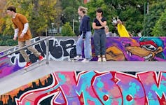 Skateboarders chatting at Riverslide Skate Park in Melbourne