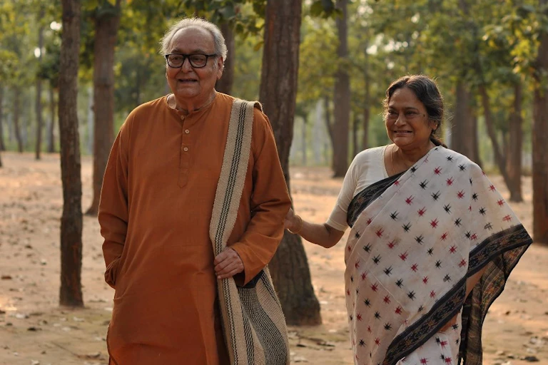 An elderly couple holding hands.