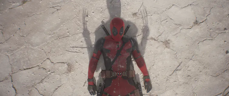 Deadpool lying in Wolverine's shadow.