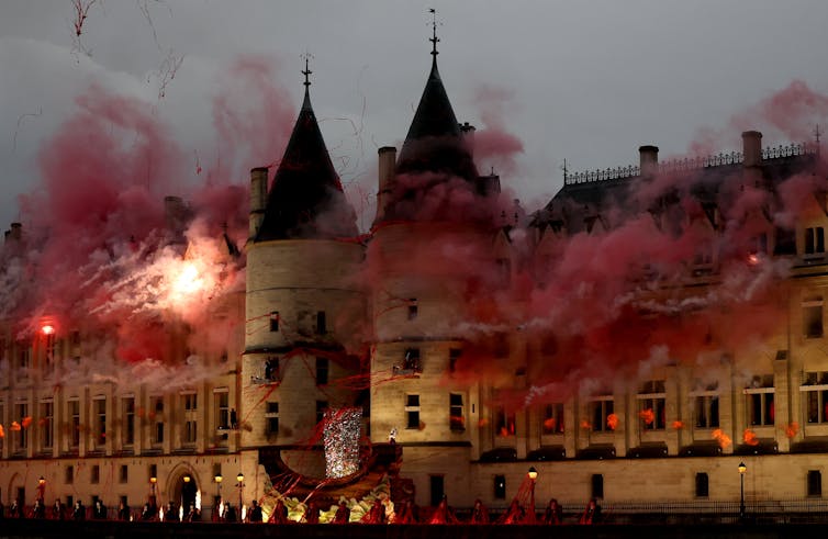 An historic building, seemingly covered in red smoke.