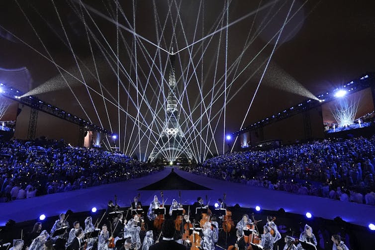 An orchestra in front of the Eiffel Tower.