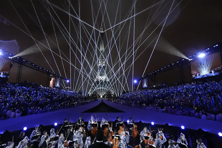 An orchestra in front of the Eiffel Tower.