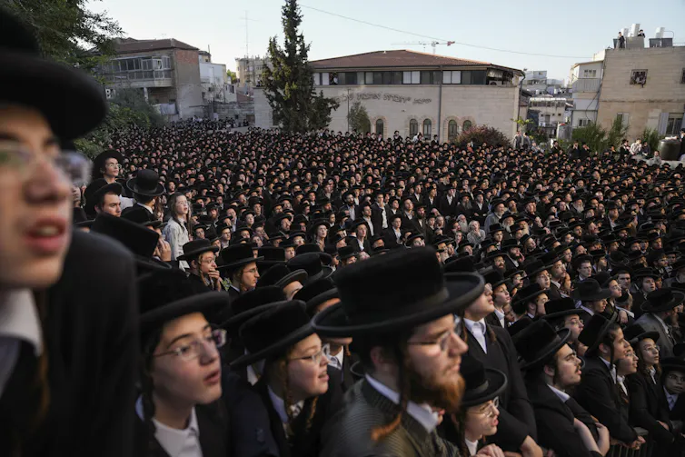 Ultra-Orthodox Jewish men attend a rally against army recruitment.