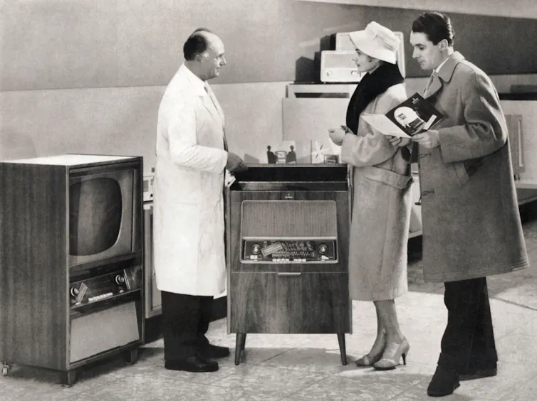 Young couple buying a TV in the 1950s