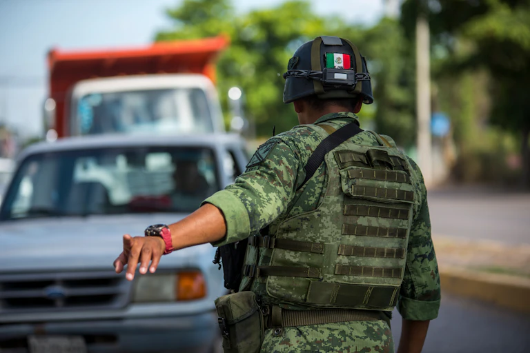 A Mexican soldier directing traffic.