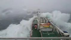 The prow of a ship is battered by waves