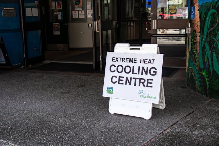 building with white sign outside the entrace with words 'extreme heat cooling centre'