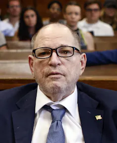 A man in glasses and a suit.