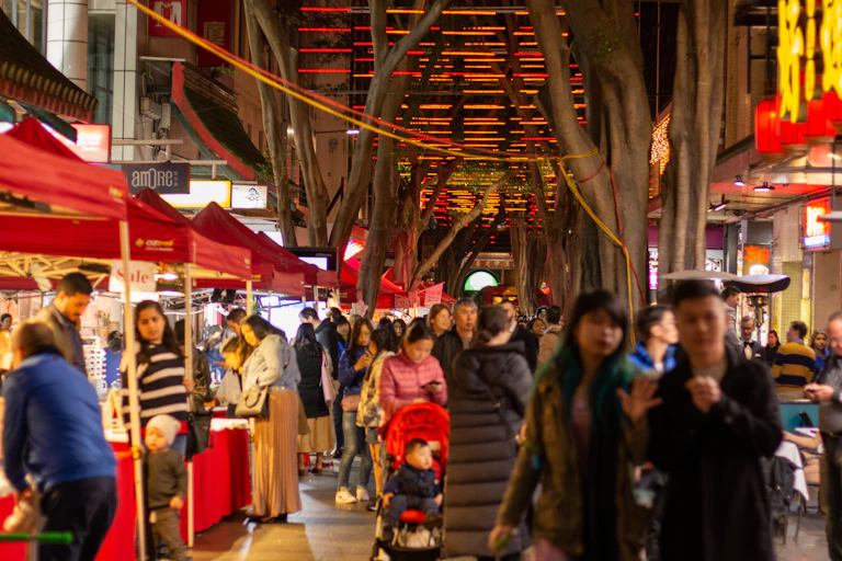 Crowds of diverse Australians walk through Chinatown