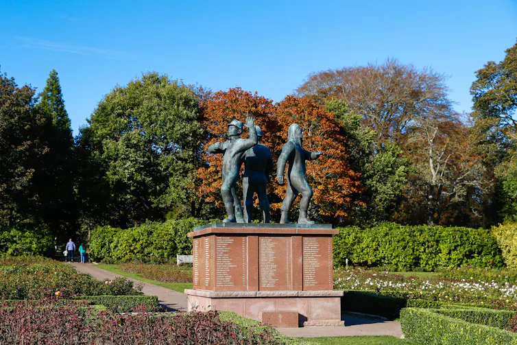 memorial statue in Aberdeen for Piper Alpha victims showing oilmen on top of a granite plinth