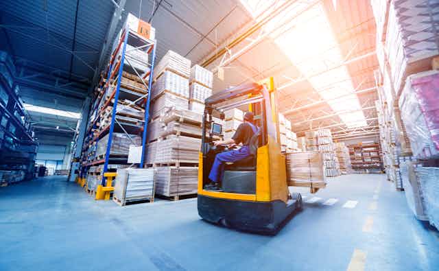 warehouse worker driving a forklift truck