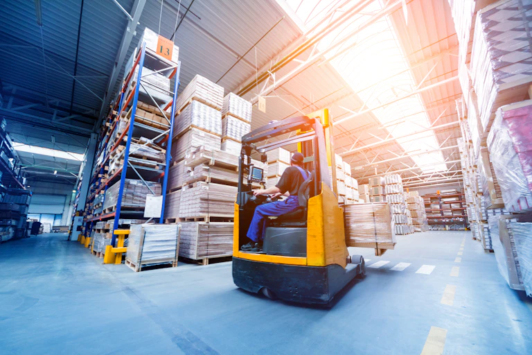 warehouse worker driving a forklift truck