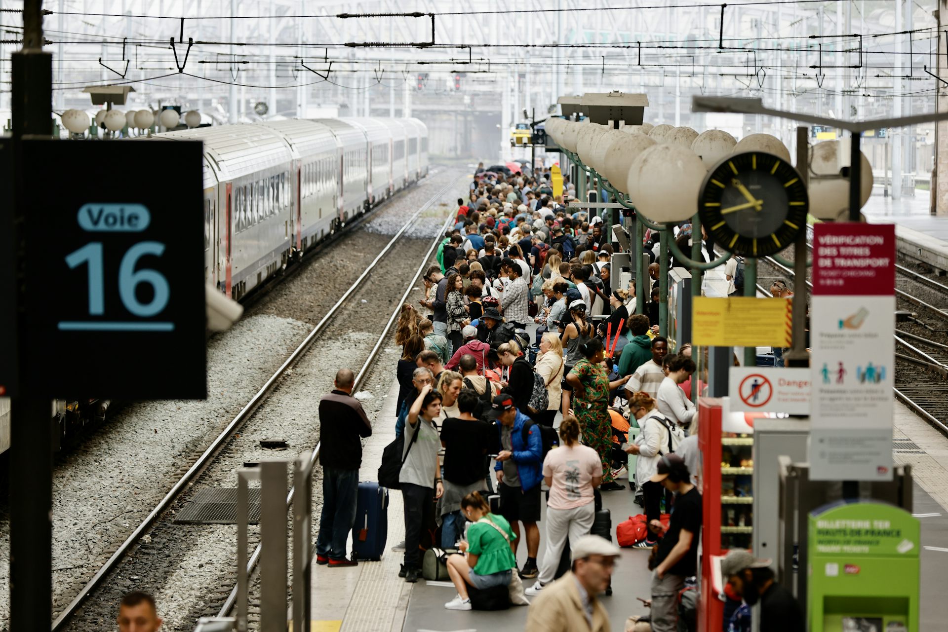 Stranded passengers on a railway station platform waiting for a train.