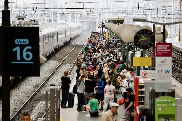 Stranded passengers on a railway station platform waiting for a train.