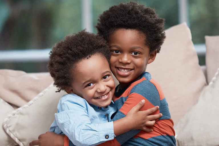 Two siblings hugging.
