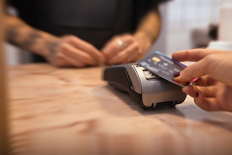 Woman buy take away coffee using credit card