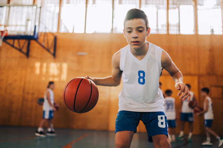 A boy bouncing a ball.