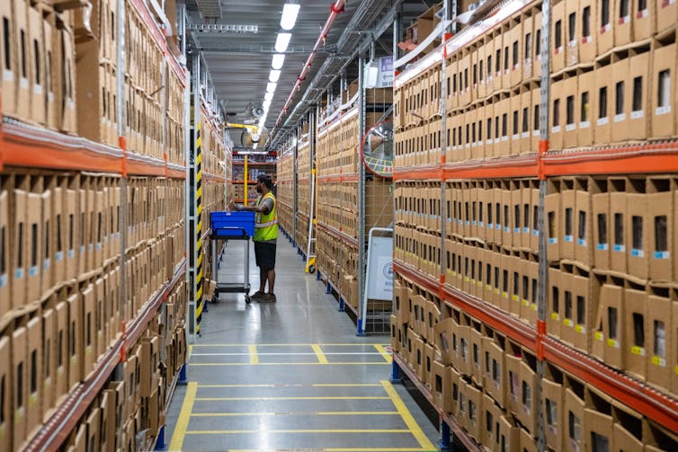 woman in warehouse filling trolley