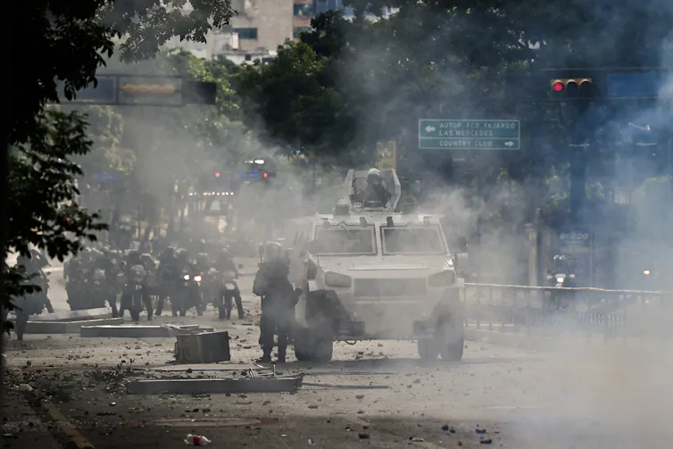 An armored vehicle is seen in a cloud.