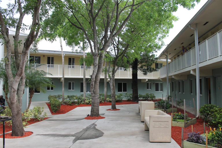 Apartments and trees in a courtyard of a permanent supportive housing complex