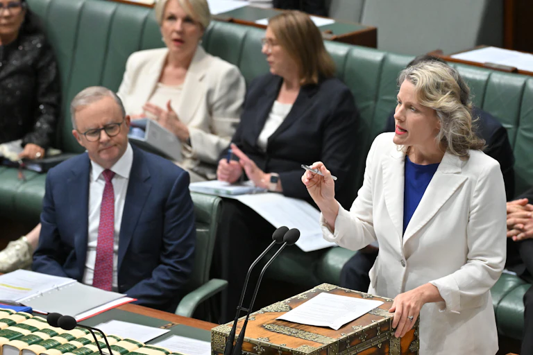 Prime Minister Anthony Albanese watches his minister, Clare O'Neil, speak in parliament