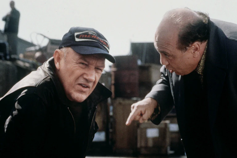 Film still. Two men in black.