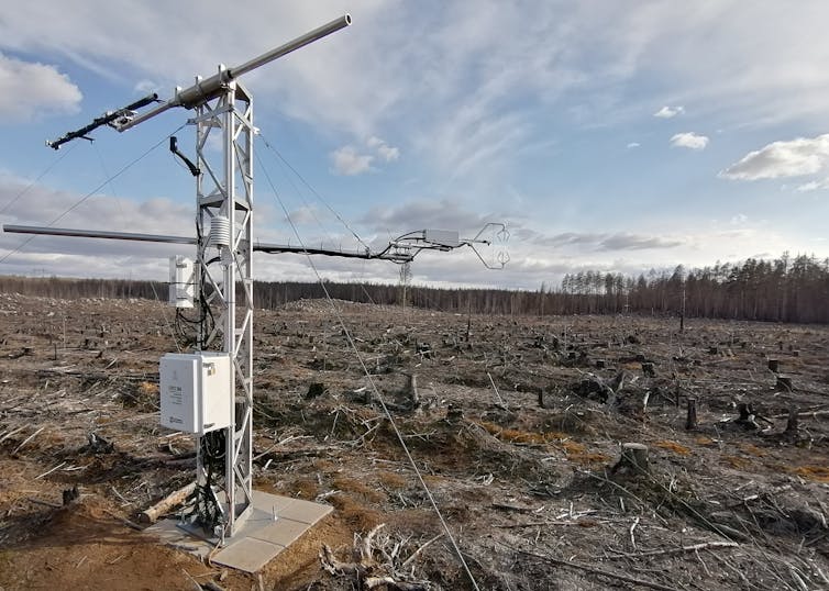 A metal mast stood in a scorched field.