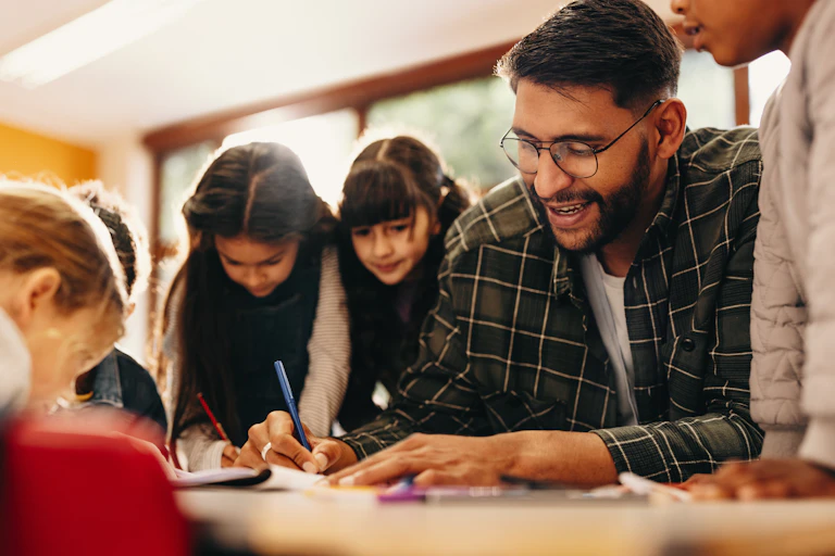 Teacher showing children how to draw