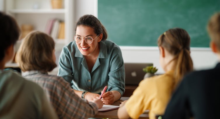 Teacher smiling at pupils