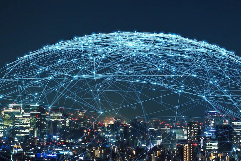 night time urban skyline with blue electonic lines in dome connecting with each other