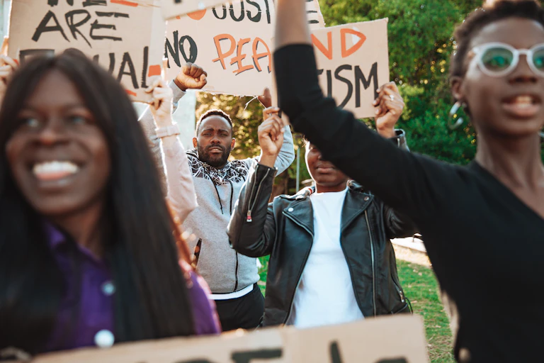Anti-racism protest, with Black protestors holding hand-made signs on cardboards.