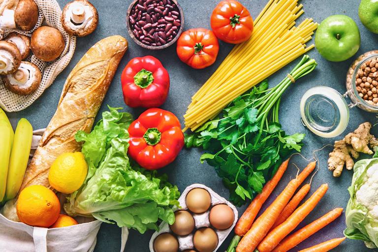 An array of fresh fruit, vegetables, bread and eggs.