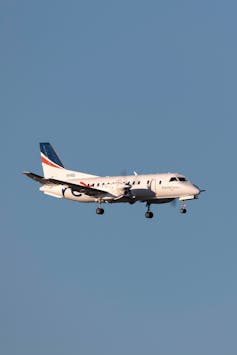 A small Rex Airlines turboprop plane flying in the air
