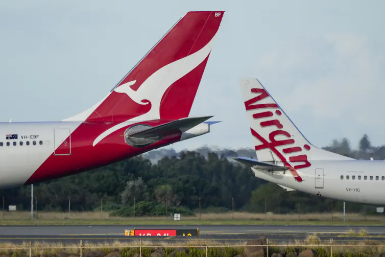 Two airplanes parked on a tarmac