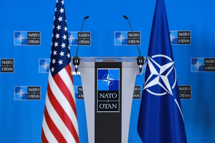US and Nato flags next to each other.